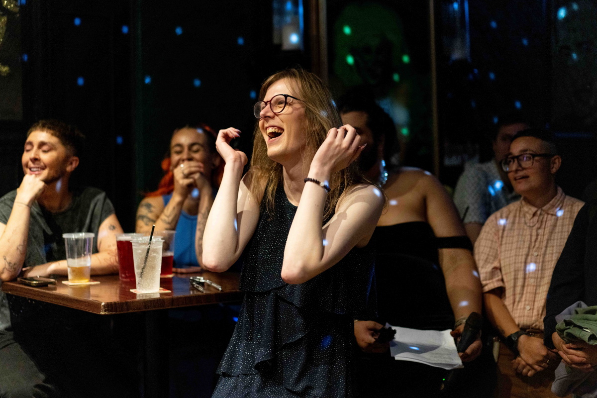 Luna laughing among other people at TRANSFER Cabaret